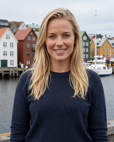 Icelandic woman Sigridur smiling at Reykjavik harbor with colorful houses behind her