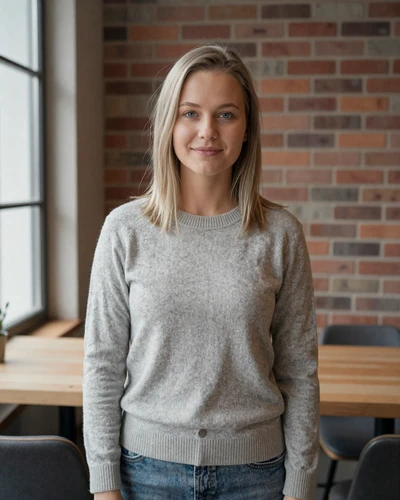 Estonian woman Marika smiling in a modern Tallinn cafe with Nordic minimalist decor