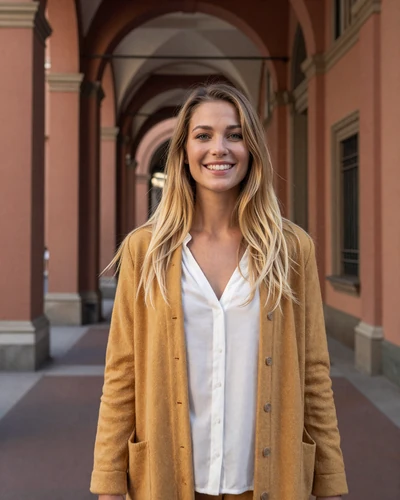 Italian woman Eleonora walking under red portico arches in Bologna historic center