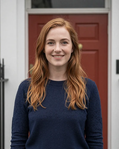 Irish woman Aoife smiling outside a colorful Georgian door in Dublin