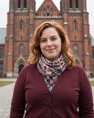 Danish woman Emilie in front of Roskilde Cathedral with autumn colors