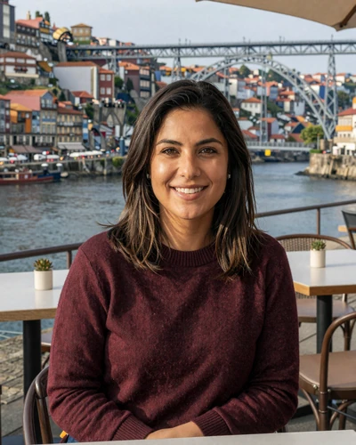 Portuguese woman Mariana at a riverside café in Porto with Dom Luís bridge behind