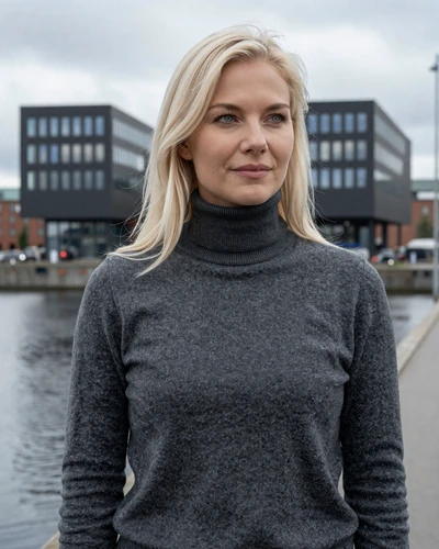 Danish woman Ida on the Aalborg waterfront with modern Scandinavian architecture