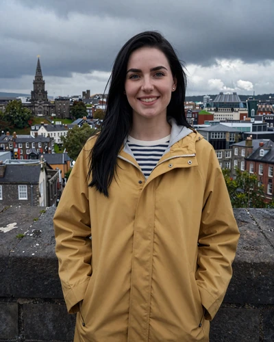 Irish woman Aisling standing on the historic Derry Walls with city panorama