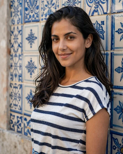 Portuguese woman Carolina leaning against blue azulejo tiles in Lisbon Chiado