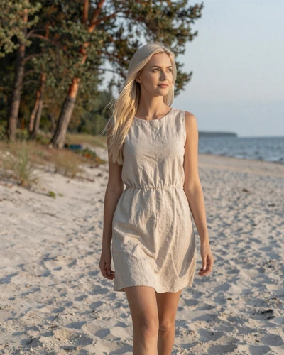 Latvian woman Dace walking on white sand beach in Jūrmala Latvia