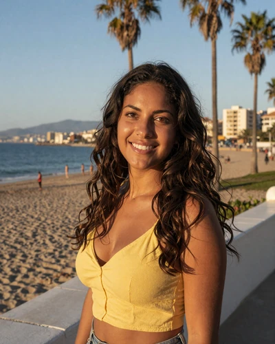 Spanish woman Carmen on the Málaga beach promenade with Mediterranean Sea and palm trees behind