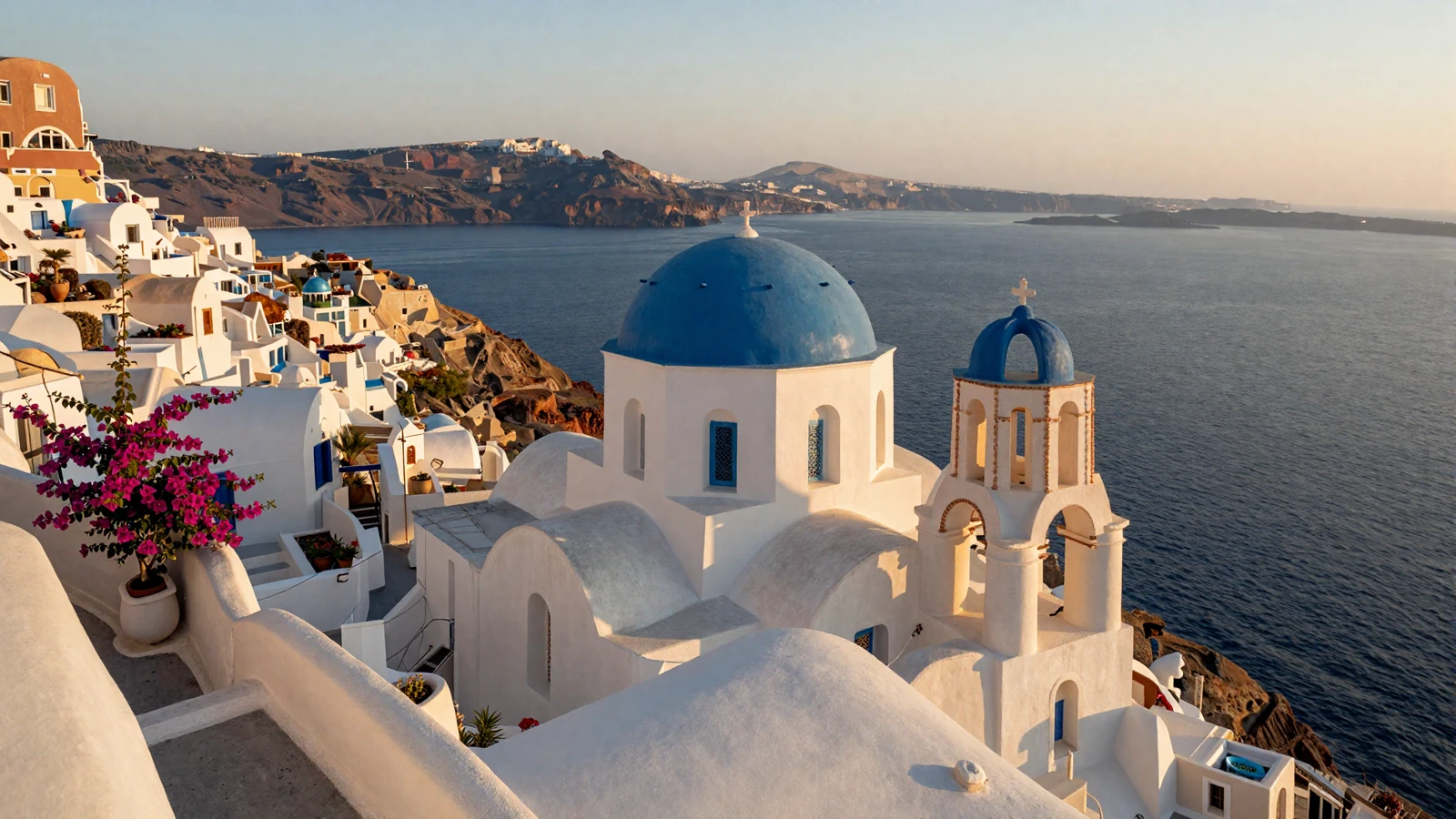 Blue-domed churches of Santorini Greece overlooking the Aegean Sea at golden hour for Greek women dating