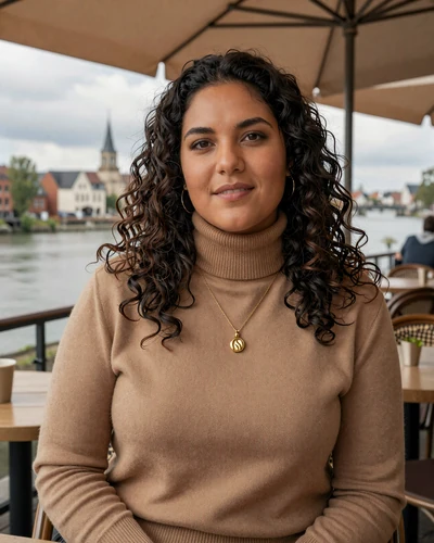 Wallonian Belgian woman Sophie at a cafe terrace in Liège near the Meuse river