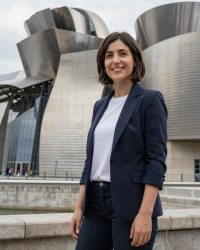 Spanish Basque woman Paula near the Guggenheim Museum in Bilbao with titanium curves behind