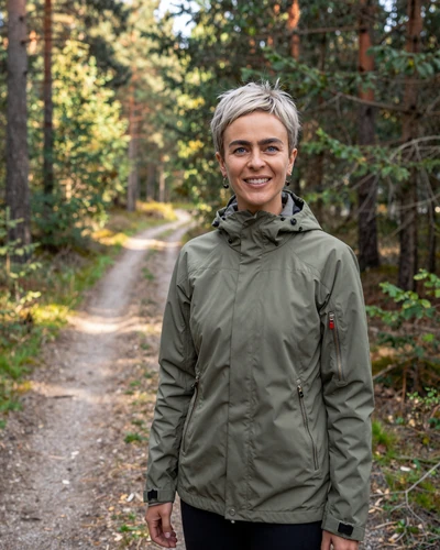 Swedish woman Frida on a forest trail near Linköping embracing friluftsliv