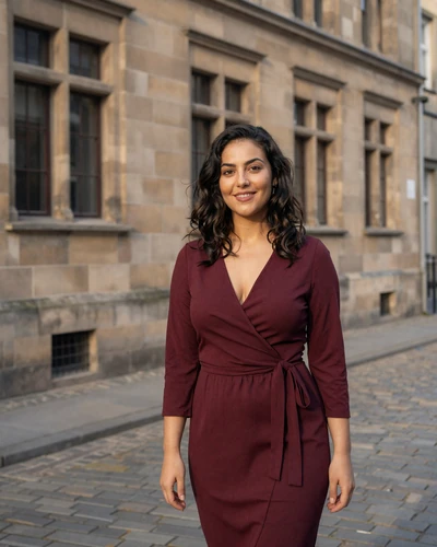 Dutch woman Noor in front of a historic Maastricht limestone building
