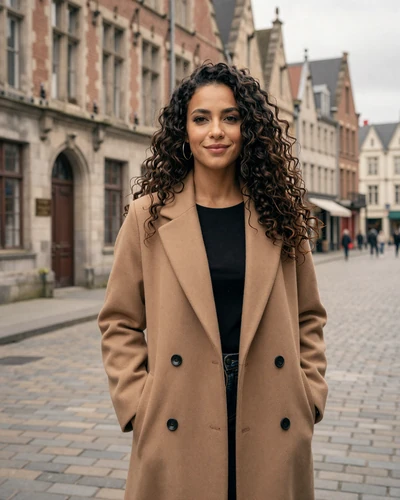 French woman Inès on a cobblestone street in Lille with Flemish architecture