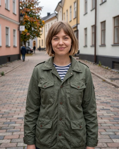 Finnish woman Saara on a cobblestone street in Turku old town in autumn