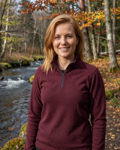 Latvian woman Marta in Gauja National Park Latvia with autumn forest behind