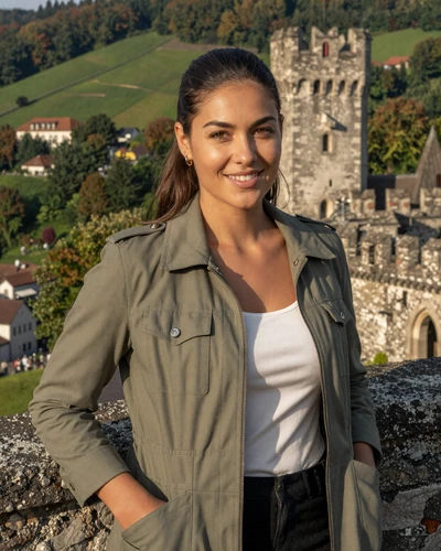 Liechtenstein woman Sabrina near Gutenberg Castle in Balzers with green hills