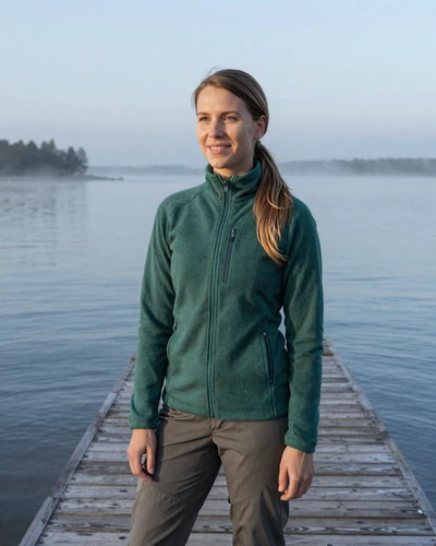 Estonian woman Maris on a Baltic Sea pier in Haapsalu with misty coastal waters